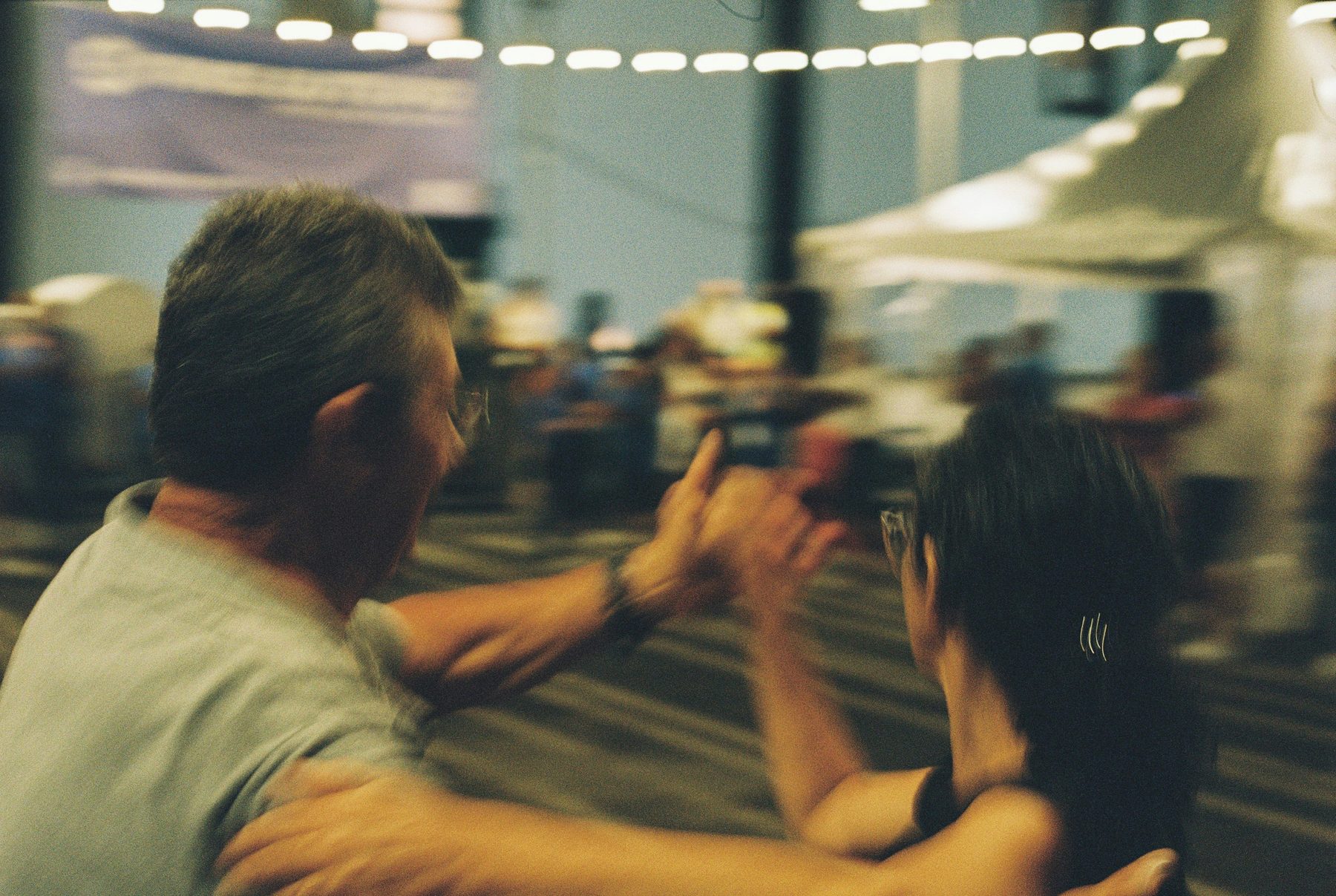 A teacher giving close attention to a dancer's hand position