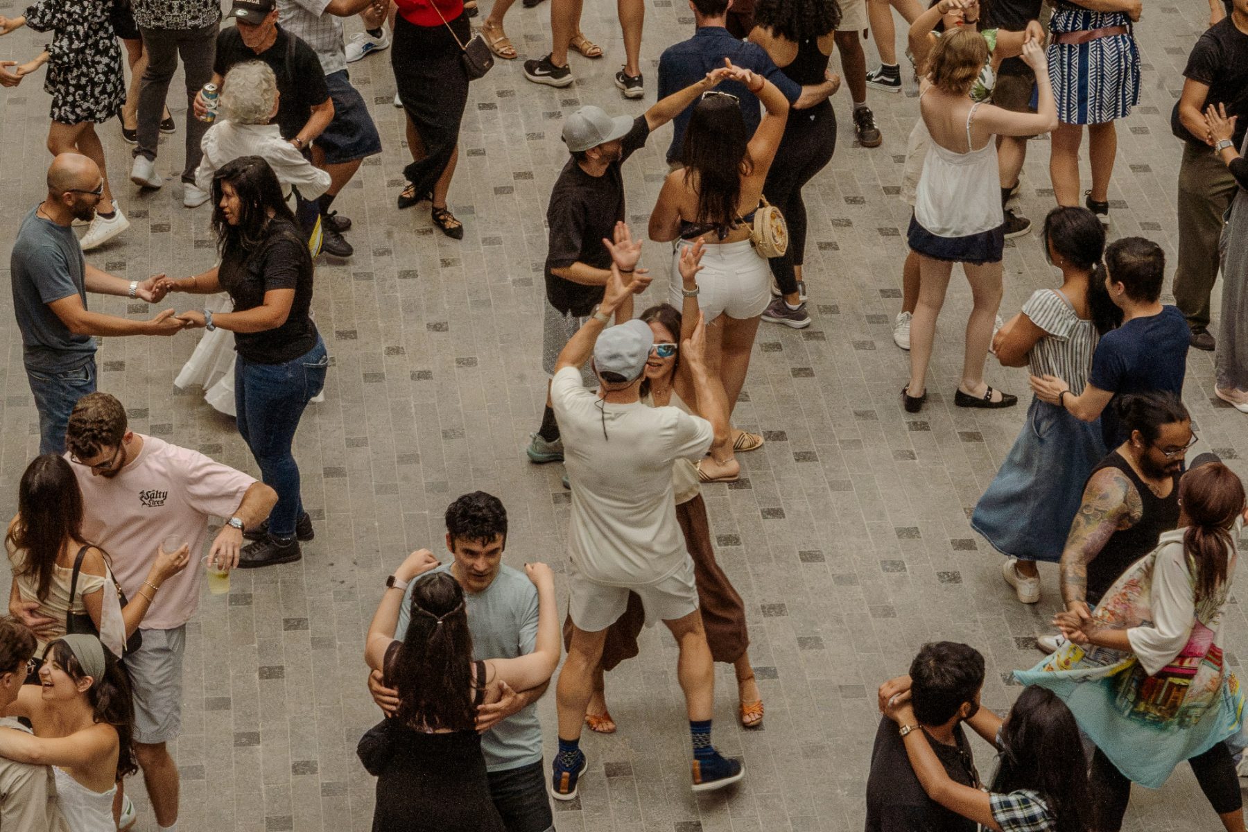 A full Salsa social with many couples sharing the dance floor